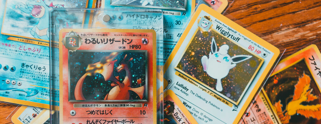 Pokémon cards stacked on a table.